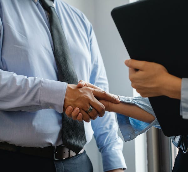 Man and woman shaking hands in office